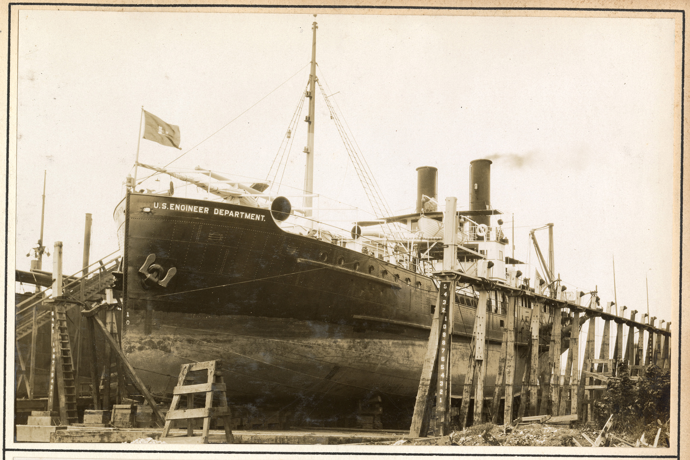 Large dredge ship with engineer flag on the bow